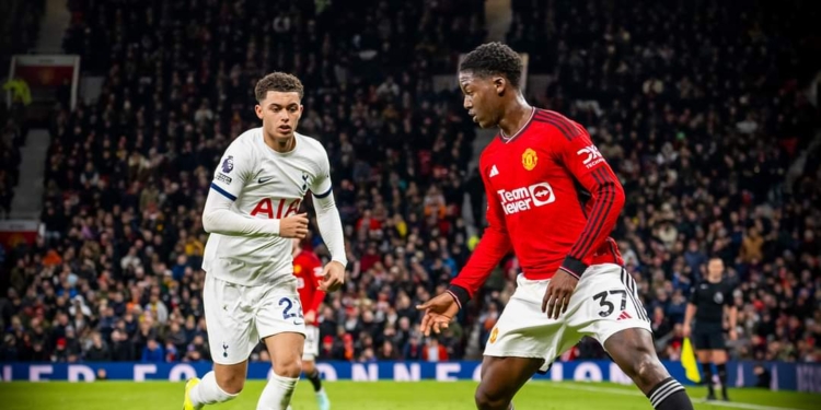 MANCHESTER, ENGLAND - JANUARY 14: Kobbie Mainoo of Manchester United in action with Brennan Johnson of Tottenham Hotspur during the Premier League match between Manchester United and Tottenham Hotspur at Old Trafford on January 14, 2024 in Manchester, England. (Photo by Ash Donelon/Manchester United via Getty Images)