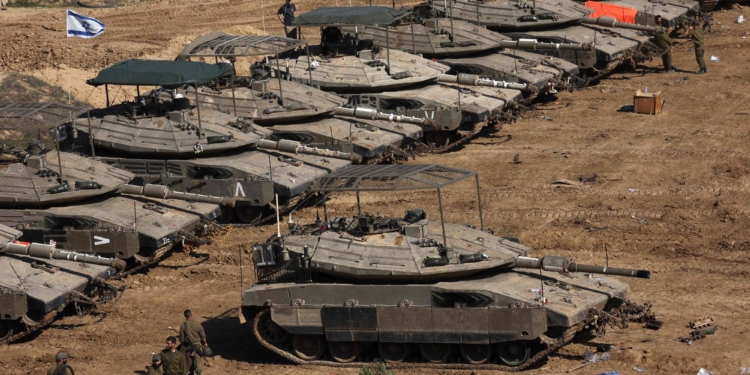 Israeli troops gather with their military vehicles on the border with the Gaza Strip on November 30, 2023, on the 7th day of a truce in battles between Israel and Hamas militants. Israel and Hamas have agreed to extend by one more day a truce under which hostages are exchanged for Palestinian prisoners and aid flows into the war-devastated Gaza Strip. (Photo by GIL COHEN-MAGEN / AFP)