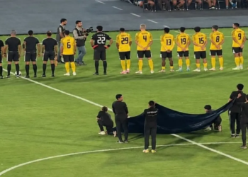 فريق بالزي الأصفر يقف أمام طاقم التحكيم قبل انطلاق المباراة